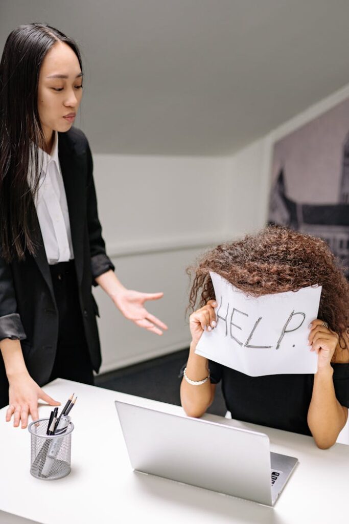 An office scene depicting stress and pressure with a dramatic help sign.